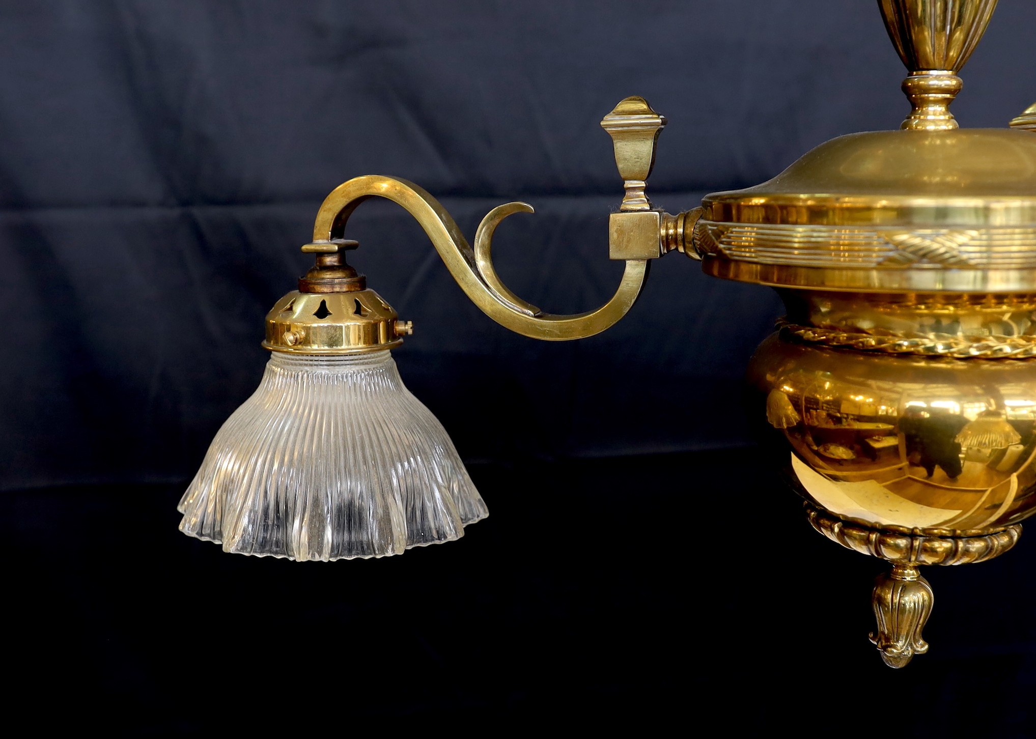 An Edwardian lacquered brass three light chandelier with ribbed glass shades, height 70cm. width 60cm